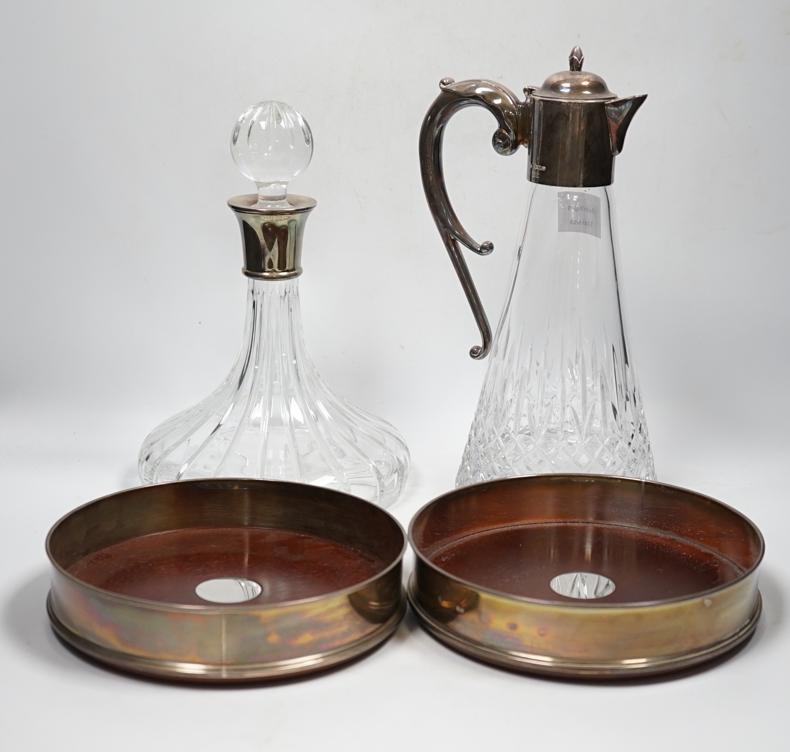 A Carr's of Sheffield modern silver mounted cut glass ship's decanter and stopper with matching silver mounted decanter coaster, Sheffield, 2007/8, one other similar decanter coaster and a silver mounted glass claret jug